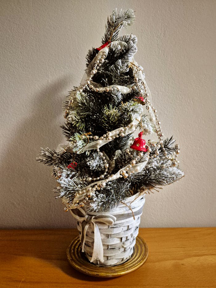 Charming decorated miniature Christmas tree in a woven basket for festive decor.